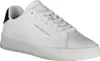 A white Tommy Hilfiger sneaker is shown from a side angle against a white background. Voir les images du produit