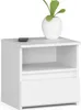A white nightstand with one drawer and an open shelf, topped with a white vase containing a green plant. A remote control sits on the top surface. Produktbild-Vorschau