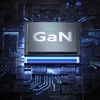 A close-up, stylized image of a GaN chip on a dark, circuit-board-like background with blue lighting. Náhled obrázku produktu