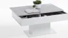 A modern coffee table with a concrete-look top and white base, featuring storage compartments. Podgląd zdjęcia produktu