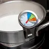 A thermometer is clipped onto the rim of a pot of white liquid, likely milk, which is on a stovetop. Produktbild-Vorschau