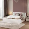 A bedroom scene with a white bed, pillows, and a fluffy throw. Produktbild-Vorschau