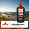 A bottle of bicycle chain oil is placed in the foreground, with a scenic road and cyclists in the background. Produktbild-Vorschau