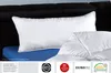 A white pillow and duvet are shown on a bed with a black headboard and a blue mattress cover. Produktbild-Vorschau