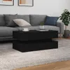 A modern living room scene with a grey sofa, a black coffee table, and a potted plant. Náhled obrázku produktu