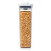 A clear, studio shot of a tall, rectangular food storage container filled with popcorn kernels. Produktbild-Vorschau