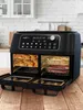 A double-chamber air fryer with food inside, set on a wooden table in a kitchen. Produktbild-Vorschau