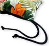 A close-up view of a cushion with a floral pattern and black drawstrings. Produktbild-Vorschau