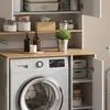 A laundry room with a washing machine and storage cabinets. Produktbild-Vorschau
