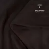 A close-up view of a dark brown soft blanket, folded to show texture and stitching. Text and icons are overlaid on the blanket. Podgląd zdjęcia produktu