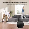 A man and a woman are in a living room with a large sectional sofa. The man is adjusting the sofa, and the woman is standing on it, wearing headphones. Produktbild-Vorschau