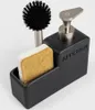 A black soap dispenser with a brush and sponge holder. Produktbild-Vorschau