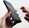 A person's hands are applying a screen protector to a smartphone. Produktbild-Vorschau