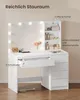 A white vanity table with a mirror and lights, featuring drawers and shelves with makeup and accessories. Voir les images du produit