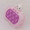 A pink toy game with a rabbit character on top, set against a light gray background. Produktbild-Vorschau