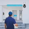 A delivery person is at a doorstep with a package, interacting with a security camera. Produktbild-Vorschau