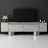 A modern TV stand with a television on top, set against a dark gray wall. Voir les images du produit