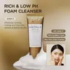 A product shot of a facial cleanser with marketing text and a model demonstrating its use. Voir les images du produit