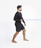 A man is performing a resistance band exercise. Podgląd zdjęcia produktu