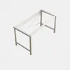 A white metal frame for a computer desk, shown from a slightly elevated angle against a plain light gray background. Anteprima dell’immagine prodotto