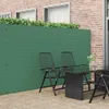 A green PVC garden fence is shown in an outdoor setting, with two chairs and a table in front of it. Anteprima dell’immagine prodotto