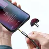 A hand is plugging a black audio cable with gold connectors into a smartphone. The smartphone screen displays a music player interface. Produktbild-Vorschau