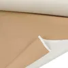 A roll of beige faux leather fabric is shown, with a section unrolled to reveal the white backing. Náhled obrázku produktu