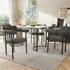 A dining set with four chairs around a table in a well-lit room.