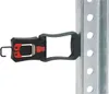 A close-up shot of a black and red clamp attached to a silver metal pole with circular holes. Náhled obrázku produktu