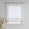 A white sheer Roman blind with a floral embroidered band is displayed on a window. Produktbild-Vorschau