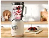 A retro-style stand mixer filled with berries and cream sits on a wooden countertop in a kitchen setting. Produktbild-Vorschau