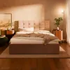 A bedroom scene with a bed, nightstands, and a floor lamp. Produktbild-Vorschau