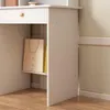 A close-up view of a white vanity table with a drawer and an open shelf containing a shopping bag and a book. Podgląd zdjęcia produktu