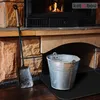 A fireplace hearth with a metal bucket and a shovel, suggesting cleaning or maintenance. Náhľad obrázku produktu