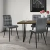 A dining room setting with a table and chairs. Produktbild-Vorschau
