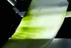 A close-up shot of a translucent green material with visible veins, backlit by a light source. Produktbild-Vorschau