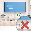 A TV mounted on a white brick wall above a white shelf unit with a cable management channel. Produktbild-Vorschau