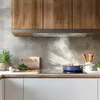 A modern kitchen scene with cooking in progress. Voir les images du produit
