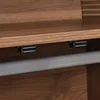 A close-up view of the underside of a wooden shelf with two black magnetic catches and a silver metal rod. Produktbild-Vorschau
