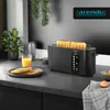 A black toaster with two slices of toast in it, sitting on a kitchen counter next to a glass of orange juice and a plate of toast. Anteprima dell’immagine prodotto