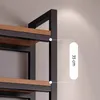 Close-up view of a shelf unit's metal frame and wooden shelf, with a measurement indicator. Produktbild-Vorschau
