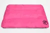 A pink dog bed with a paw print logo. Produktbild-Vorschau