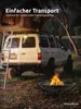 A fire pit is shown in the foreground with a tent-covered vehicle in the background, set in a natural outdoor environment. Produktbild-Vorschau