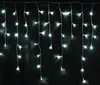 A string of white LED lights hanging against a black background. Produktbild-Vorschau