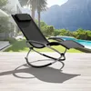A black rocking lounge chair is placed on a wooden deck next to a swimming pool with a scenic mountain backdrop. Voir les images du produit
