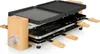A raclette grill with a bamboo frame and a reversible grill/griddle plate. Produktbild-Vorschau