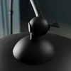 A close-up shot of the base and joint mechanism of a black floor lamp. Produktbild-Vorschau
