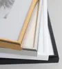 A close-up view of stacked picture frames in different colors. Produktbild-Vorschau