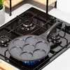 A black gas stove with a multi-cup frying pan on it. Anteprima dell’immagine prodotto