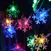 A close-up of colorful snowflake-shaped LED string lights. Produktbild-Vorschau